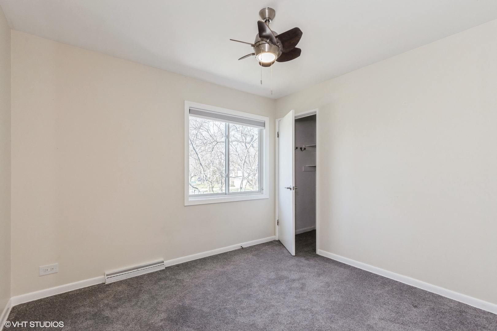 127 Riverside Drive Northfield, IL 60093 - Photo 12 of 27 an empty room with windows and ceiling fan