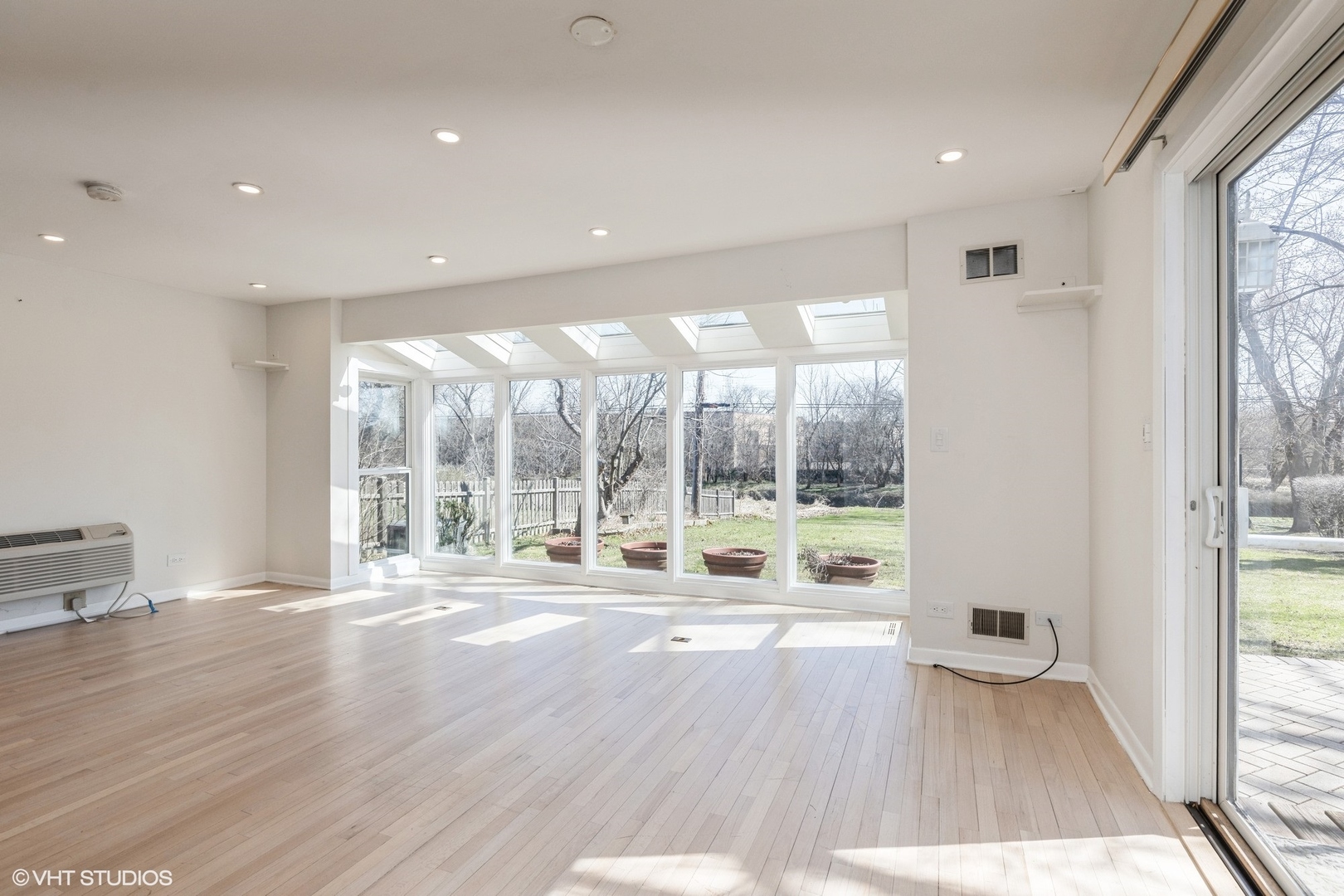 127 Riverside Drive Northfield, IL 60093 - Photo 2 of 27 a view of an empty room with wooden floor and a window