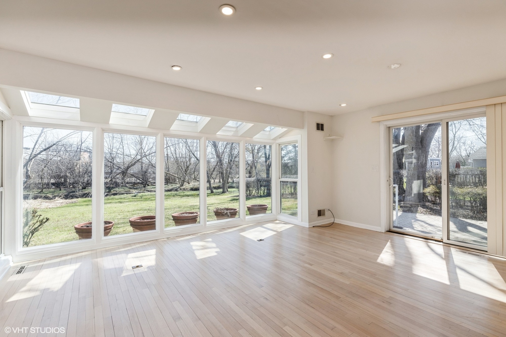 127 Riverside Drive Northfield, IL 60093 - Photo 10 of 27 a view of an empty room with wooden floor and a large window with outer view