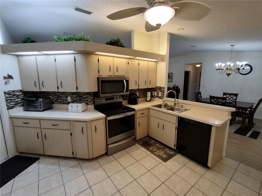 8274 Southwest 116th Street Ocala, FL 34481 - Photo 11 of 30 a kitchen with a sink cabinets and window