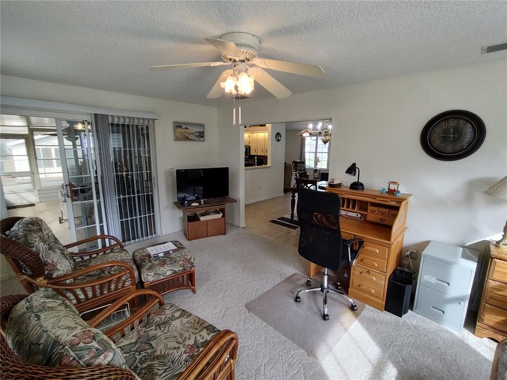 8274 Southwest 116th Street Ocala, FL 34481 - Photo 15 of 30 a living room with furniture and flat screen tv