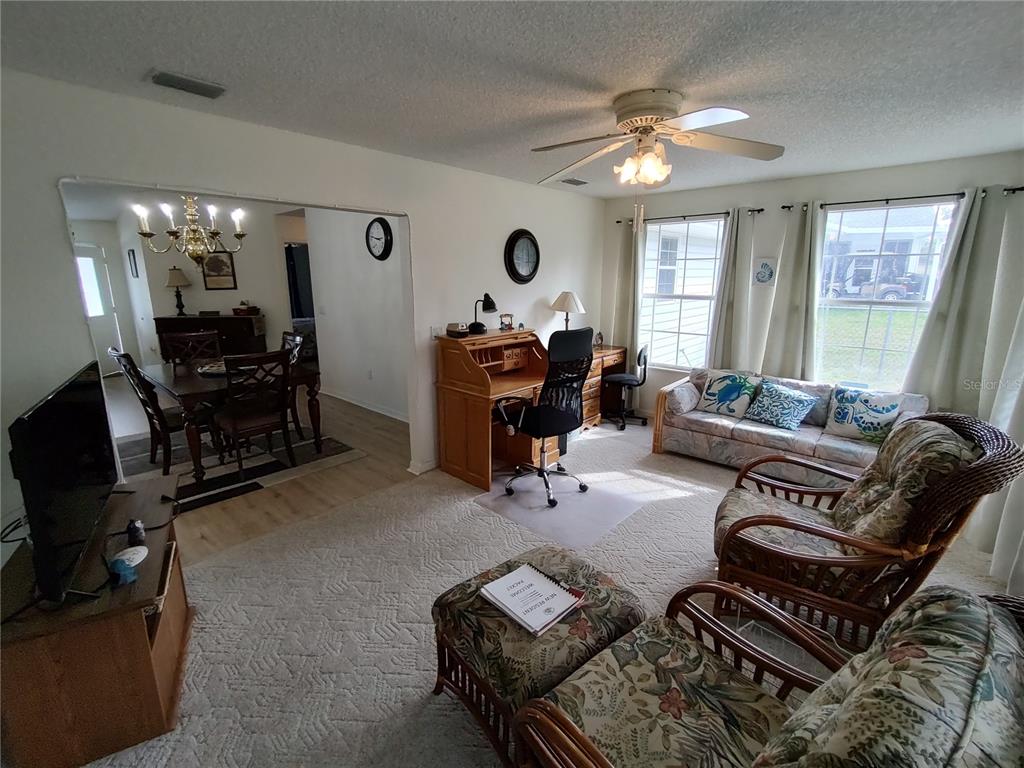 8274 Southwest 116th Street Ocala, FL 34481 - Photo 16 of 30 a living room with furniture and a flat screen tv