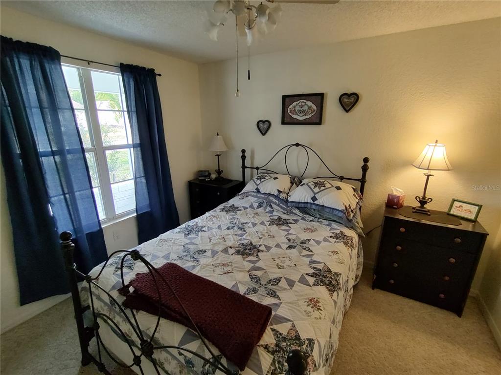 8274 Southwest 116th Street Ocala, FL 34481 - Photo 18 of 30 a bed sitting in a bedroom next to a window