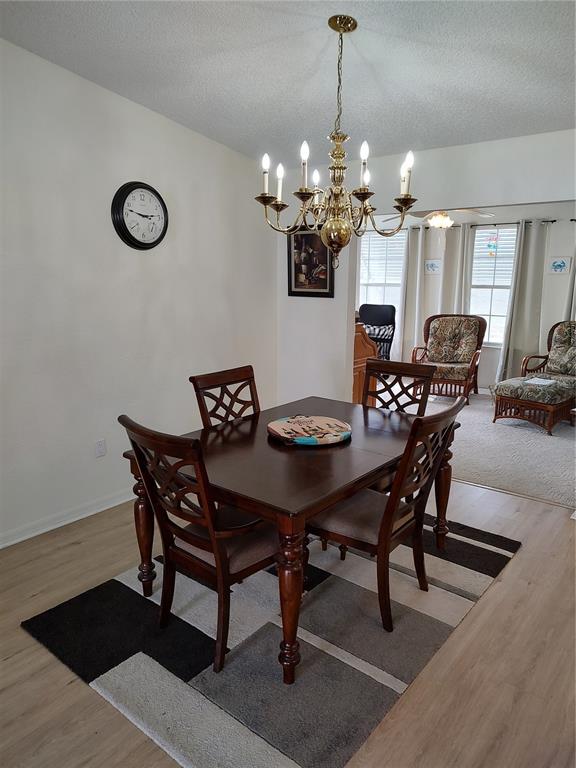 8274 Southwest 116th Street Ocala, FL 34481 - Photo 7 of 30 a view of a dining room with furniture and wooden floor