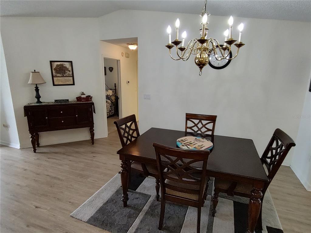 8274 Southwest 116th Street Ocala, FL 34481 - Photo 8 of 30 a view of a dining room with furniture and chandelier