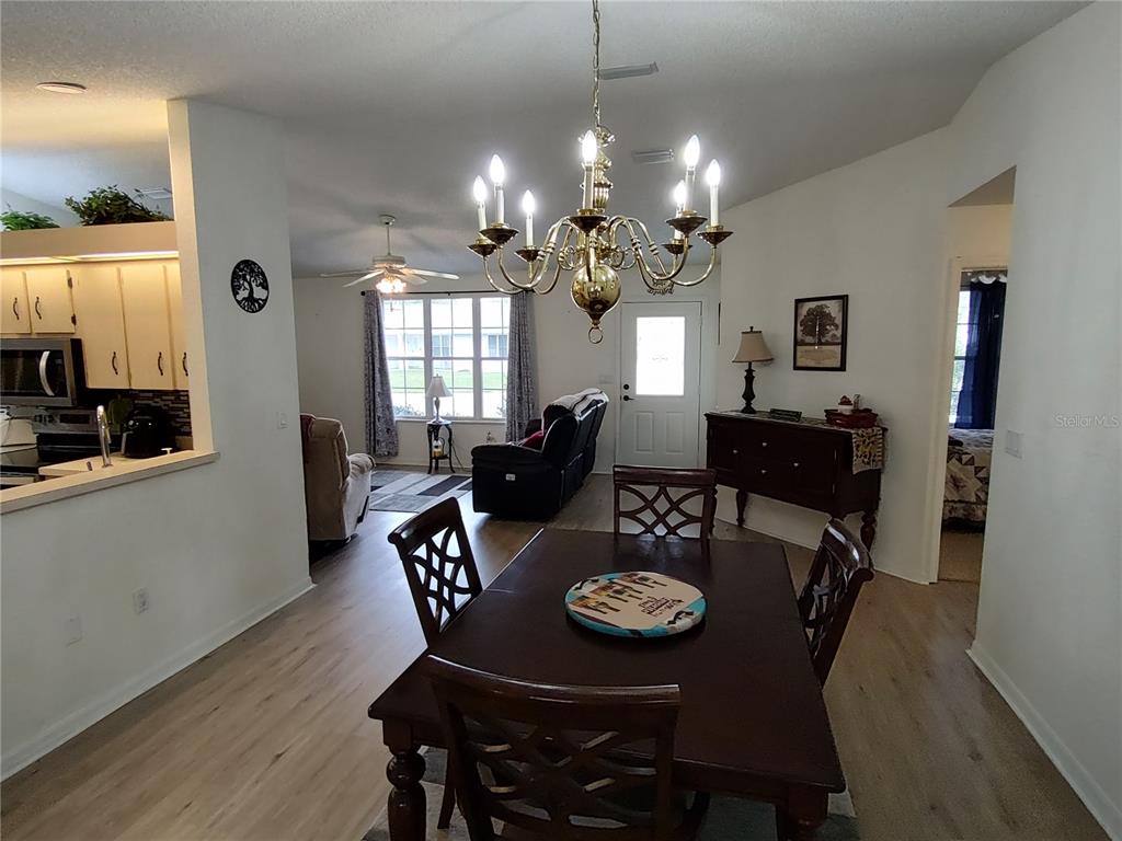 8274 Southwest 116th Street Ocala, FL 34481 - Photo 9 of 30 a view of a dining room with furniture and wooden floor