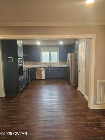 a dining room with furniture a rug and a chandelier