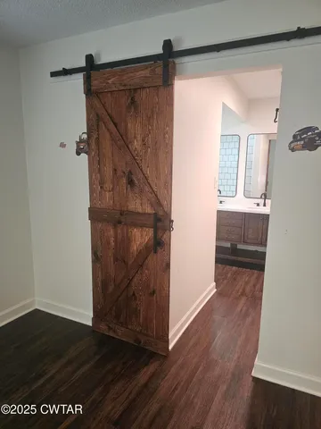 a view of a hallway view with wooden floor and staircase