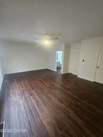 a view of a room with wooden floor and window