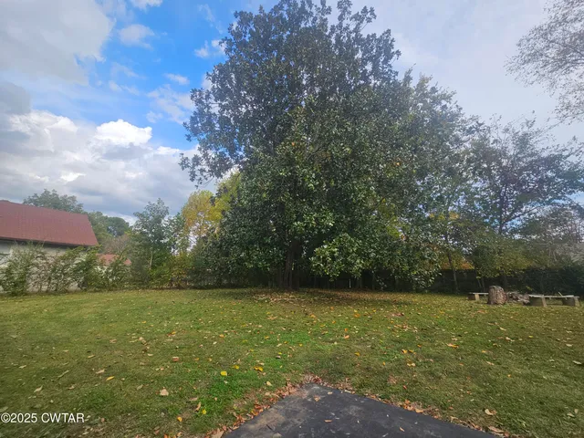 a view of outdoor space with deck and yard