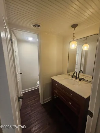 a large kitchen with granite countertop a large counter top stainless steel appliances and cabinets