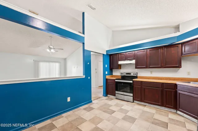 a kitchen with stainless steel appliances granite countertop a sink and cabinets