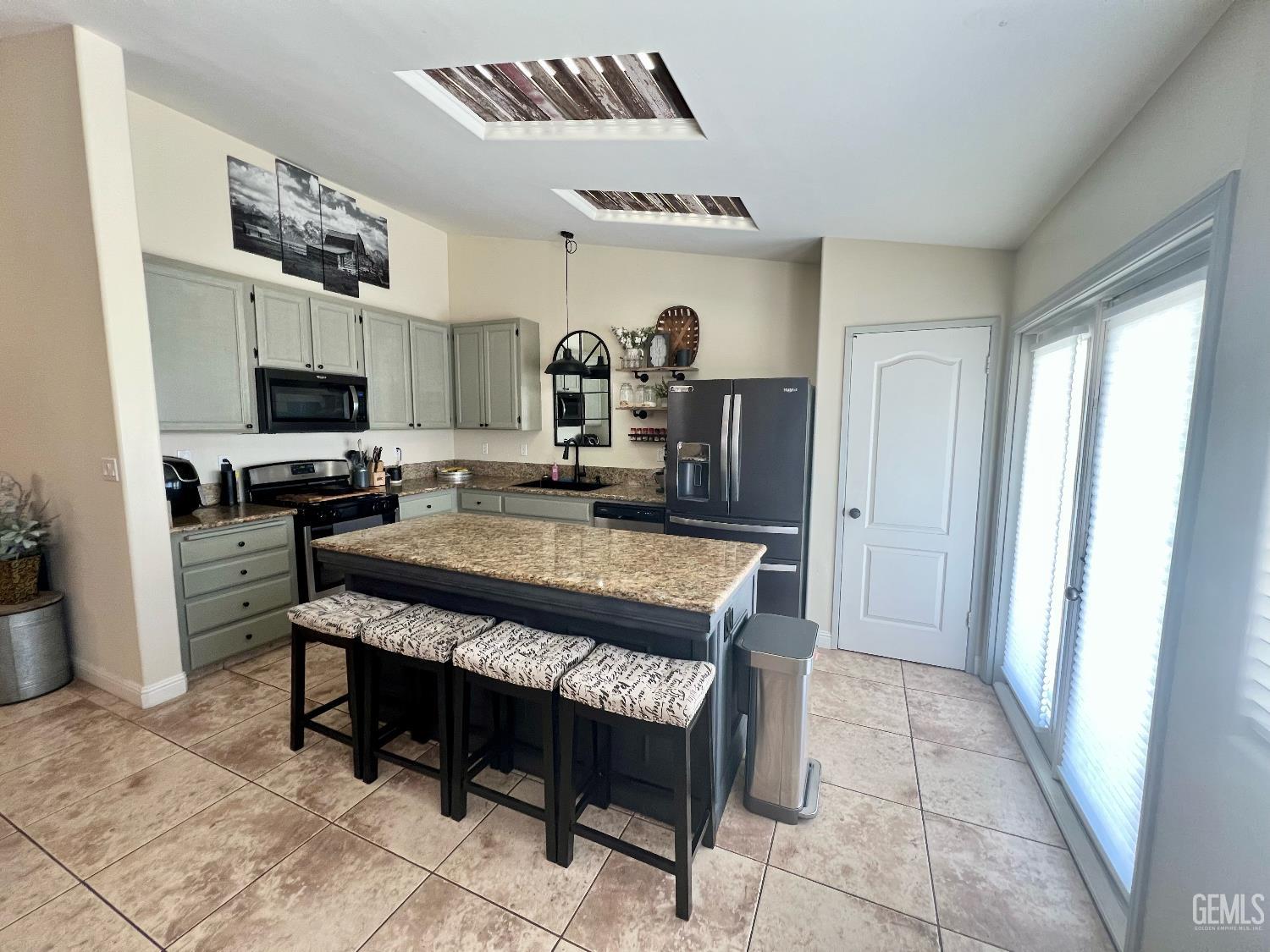 Undisclosed Address Bakersfield, CA 93312 - Photo 11 of 26 a large kitchen with a table chairs and a refrigerator