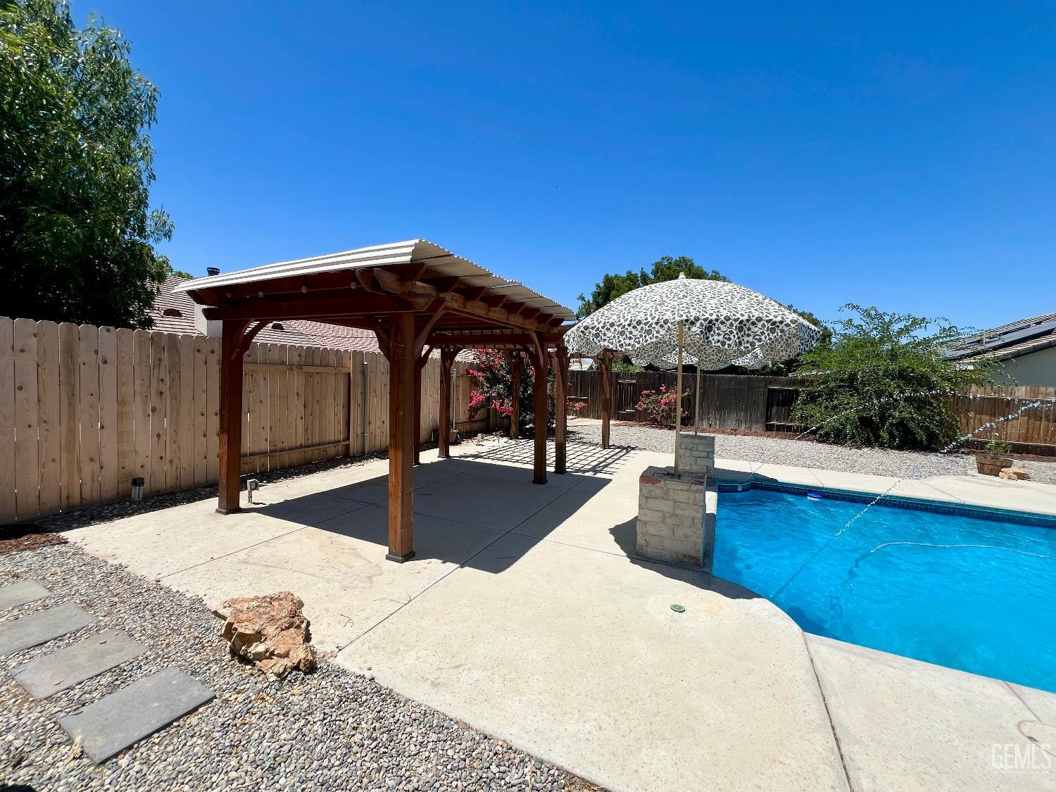 Undisclosed Address Bakersfield, CA 93312 - Photo 23 of 26 a view of a backyard with swimming pool and sitting area