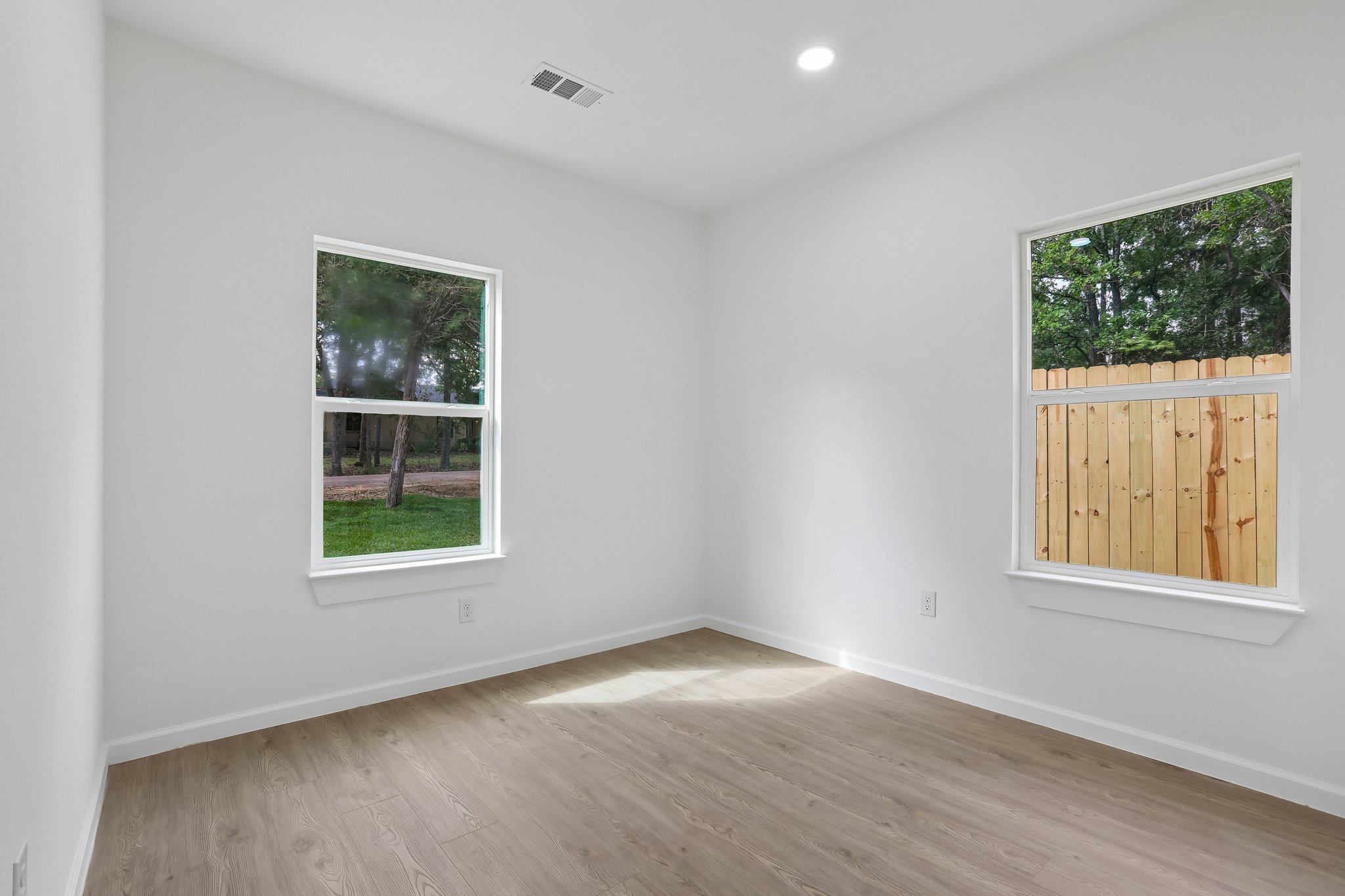 210 Flint Ridge Street Bastrop, TX 78602 - Photo 27 of 40 an empty room with wooden floor and windows