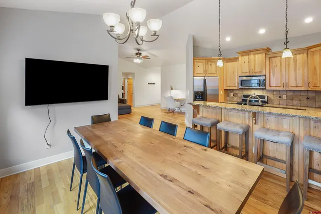 a large kitchen with a table and chairs