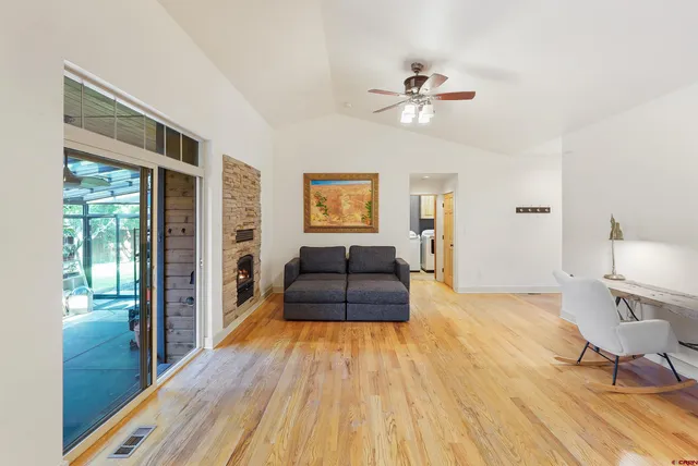 a living room with furniture and a wooden floor