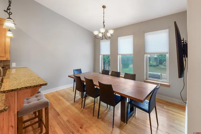 a view of a dining room with furniture window and wooden floor
