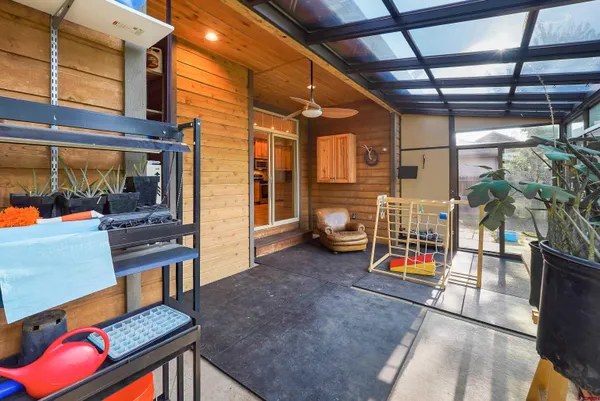 a backyard of a house with table and chairs