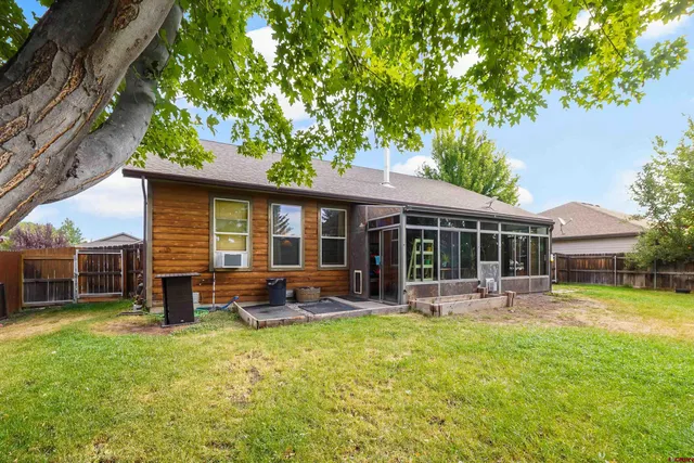 a front view of a house with a garden and trees