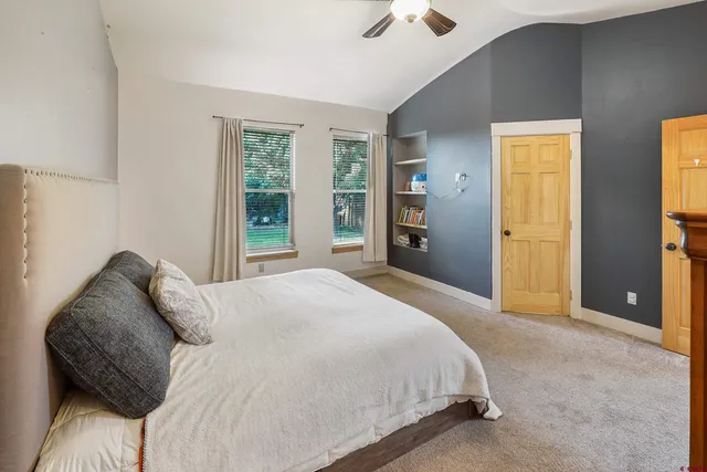 a bedroom with a bed and a window