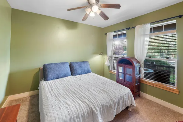 an aerial view of a city with lots of residential buildings and mountain view in back