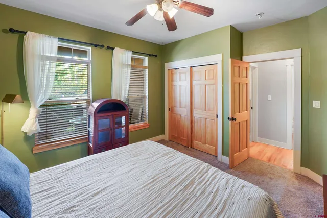 a bedroom with a bed and a large window