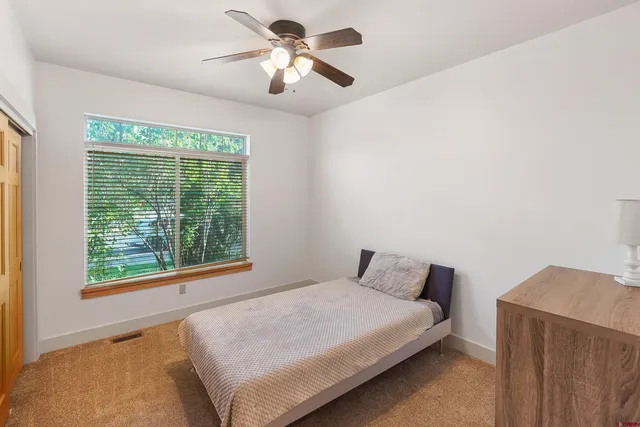 a bedroom with a large bed and a large window