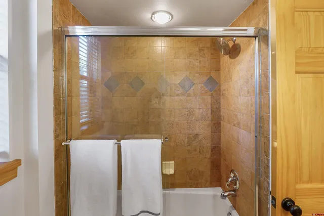 a bathroom with a shower and a tub