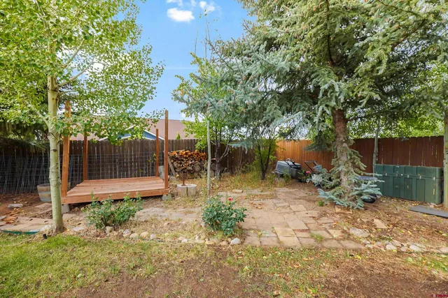 a backyard of a house with table and chairs