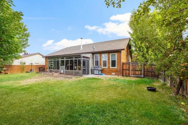 a view of a house with a yard and sitting area
