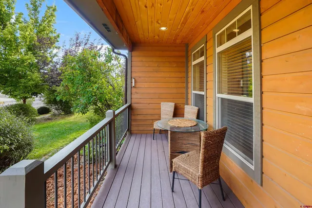 a view of balcony with wooden floor and outdoor seating