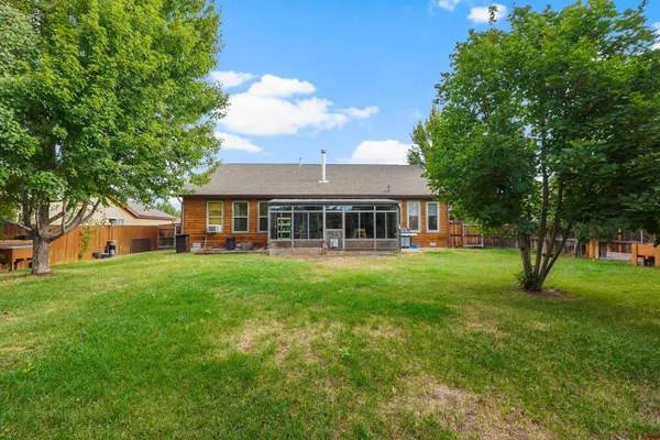 a living room with furniture and a flat screen tv with wooden floor