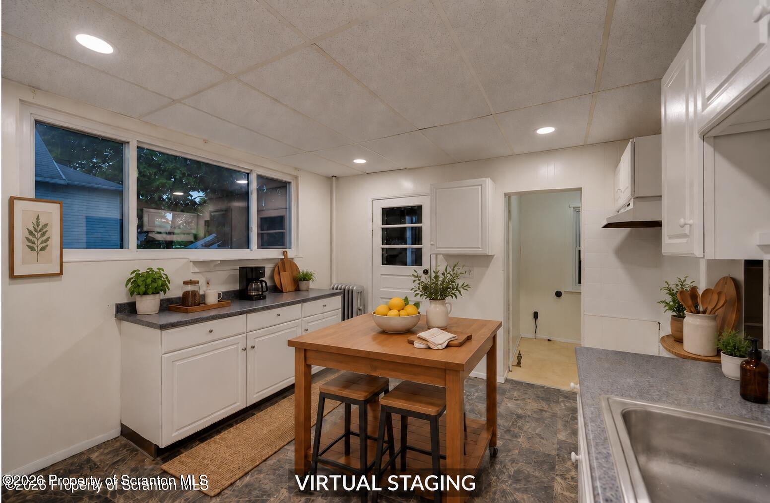 819 Delaware Street Scranton, PA 18509 - Photo 24 of 45 Warmly staged kitchen with prep island