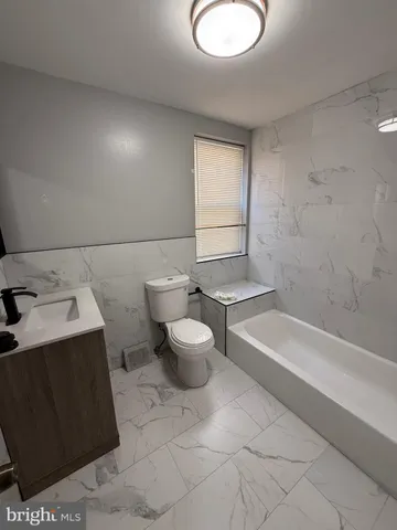 a bathroom with a bathtub sink and toilet