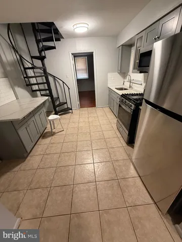 a kitchen with stainless steel appliances a refrigerator and a counter top space