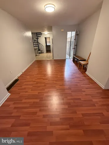 a view of a room with wooden floor