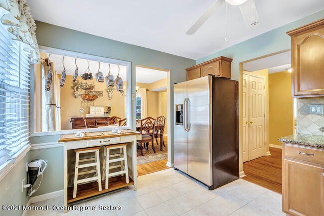 39 Kingsley Way Freehold, NJ 07728 - Photo 12 of 24 a kitchen with stainless steel appliances granite countertop a refrigerator and a stove