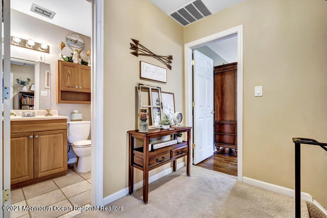 39 Kingsley Way Freehold, NJ 07728 - Photo 15 of 24 a bathroom with a toilet a sink and a mirror