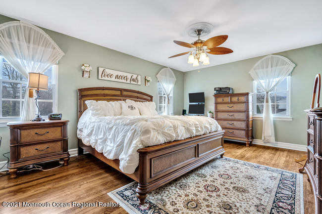39 Kingsley Way Freehold, NJ 07728 - Photo 16 of 24 a bedroom with a bed and dresser with mirror