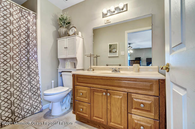 39 Kingsley Way Freehold, NJ 07728 - Photo 17 of 24 a bathroom with a sink toilet and mirror