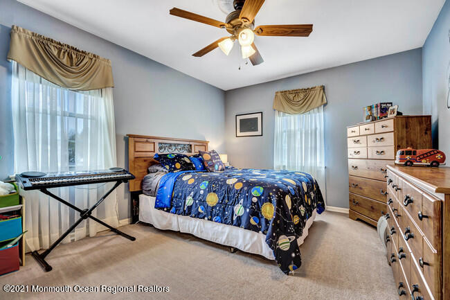 39 Kingsley Way Freehold, NJ 07728 - Photo 18 of 24 a bedroom with a bed and a chandelier