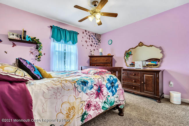 39 Kingsley Way Freehold, NJ 07728 - Photo 19 of 24 a bedroom with a bed and a dresser
