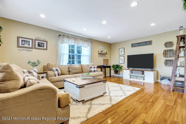 39 Kingsley Way Freehold, NJ 07728 - Photo 3 of 24 a living room with furniture and a flat screen tv