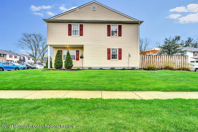 39 Kingsley Way Freehold, NJ 07728 - Photo 22 of 24 a front view of a house with a yard
