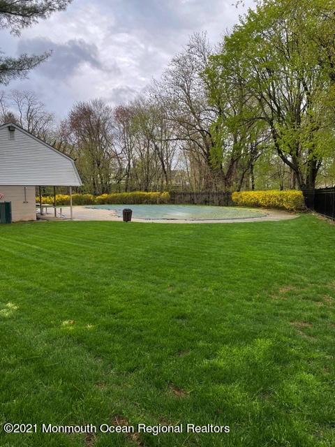 39 Kingsley Way Freehold, NJ 07728 - Photo 24 of 24 a view of yard with swimming pool and trees