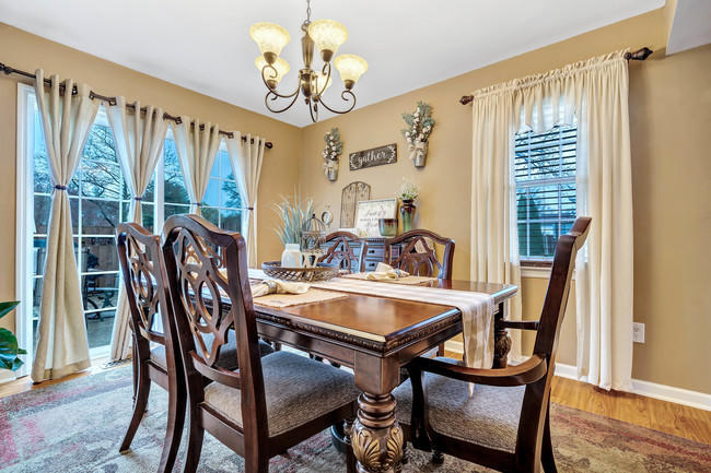 39 Kingsley Way Freehold, NJ 07728 - Photo 6 of 24 a dining room with furniture a chandelier and wooden floor