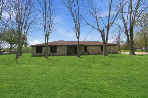 a front view of house with yard and green space