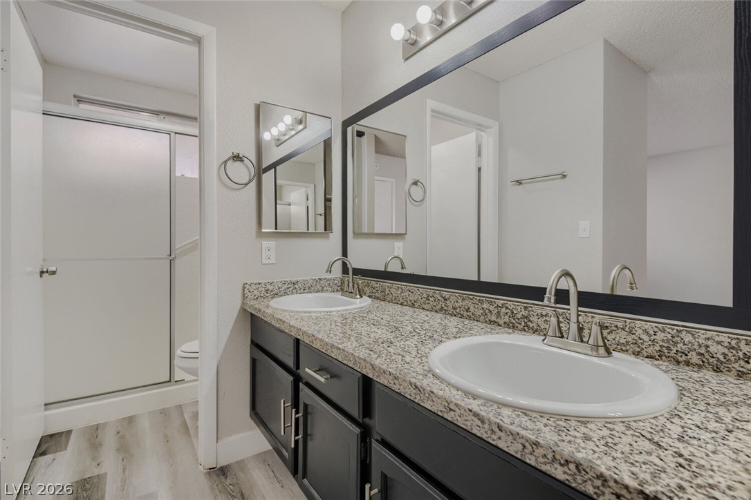 2343 Valleywood Road Henderson, NV 89014 - Photo 24 of 29 Two individual sinks provide ample space for daily routines in this well-appointed bathroom.