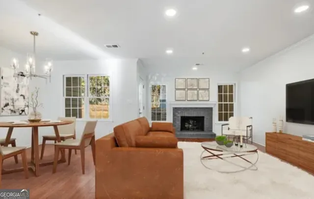 a living room with furniture a fireplace and a flat screen tv